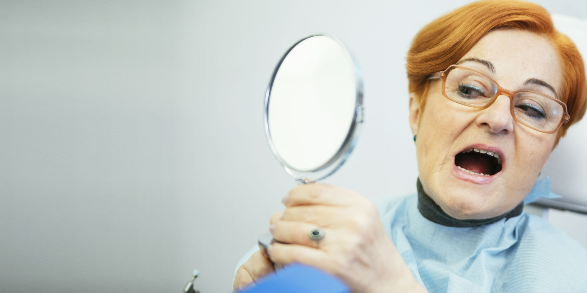 dental patient with broken restoration looking in the mirror Lafayette IN